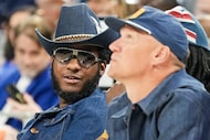 Singer Leon Bridges watches from courtside during the first half of an NBA preseason...