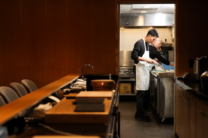Tatsu Dallas sous chef Yoji Ishii filets a fish alongside head chef Tatsu to prepare for the...