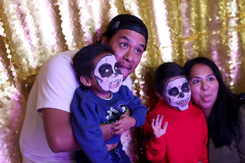 Jordy Garcia poses for a photo within a studio with Diego, 3, during Dia De Los Muertos...