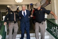 Megachurch founder Robert Morris is escorted out of the courthouse after pleading guilty to...