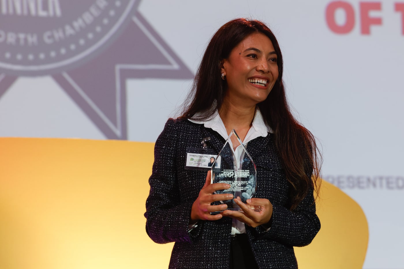 Chief Caregiving Officer Sabina Tamang receives a Small Business of the Year award during...