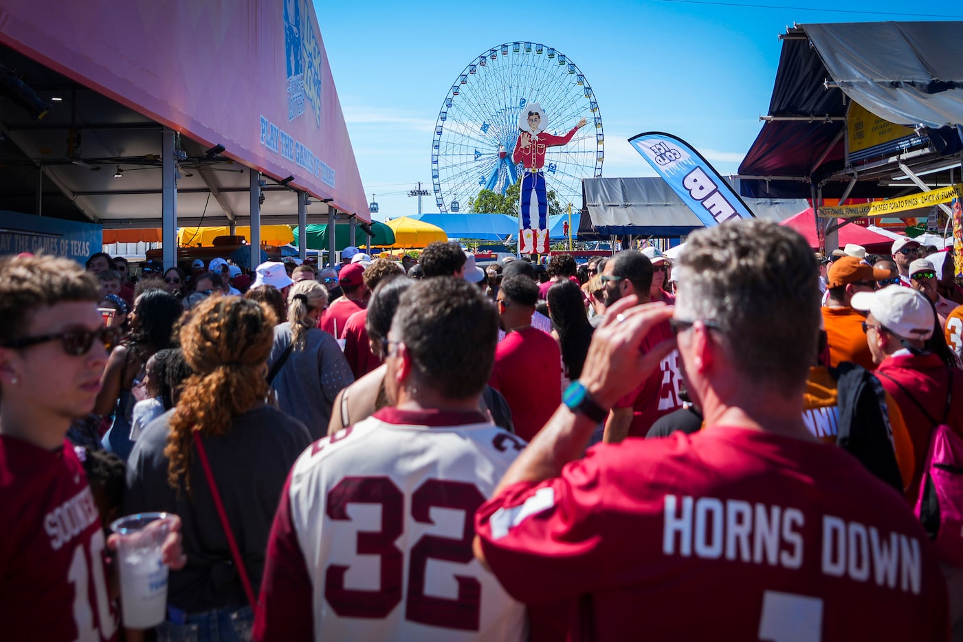 Oklahoma fans join Texas fans on the midway before the Red River Rivalry NCAA college...