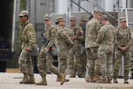 Military personnel in uniforms bearing Texas National Guard patches are seen at the U.S....