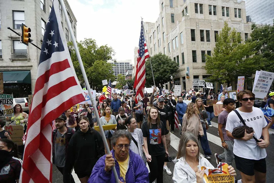 A large crowd marches through downtown streets during the No Kings protest in Fort Worth on Saturday, Oct. 18, 2025.