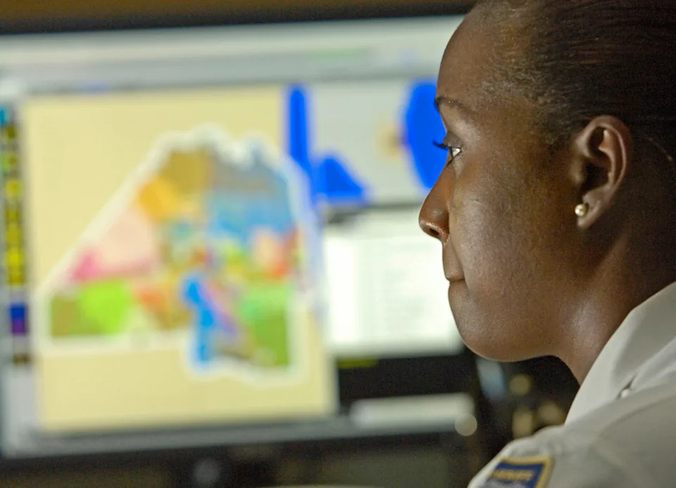 Receiving Officer Kiwana Fields listens to an emergency 911 call in the Jacksonville Sheriff's Office communications center in this 2007 photo. JSO said Oct. 6 that a former communications employee, Terrance Owens, was arrested on human trafficking charges and fired.