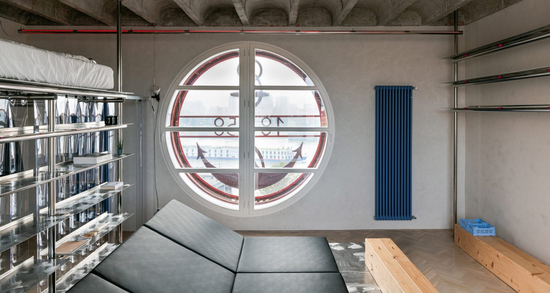 Living space in apartment with large round window