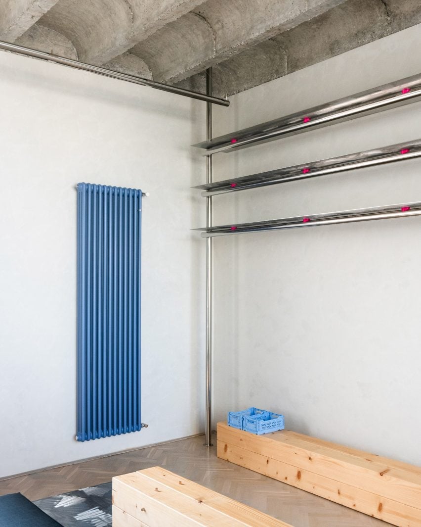 Corner of room with metal storage and blue radiator