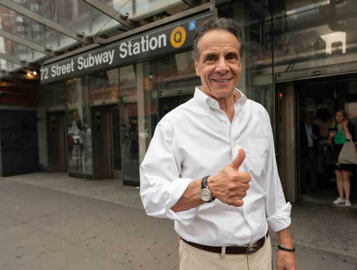 NYC Mayor’s Race: Where the candidates stand on street redesigns, bike and bus lanes, fare evasion and more 4 man wearing shirt holding thumbs up near subway station in campaign