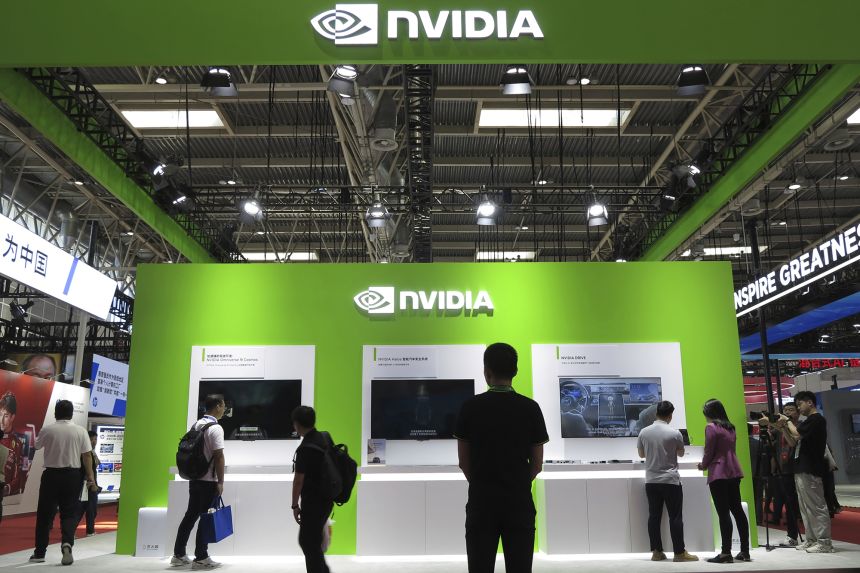 People visit the booth of Nvidia at a supply chain expo in Beijing on July 17, 2025.