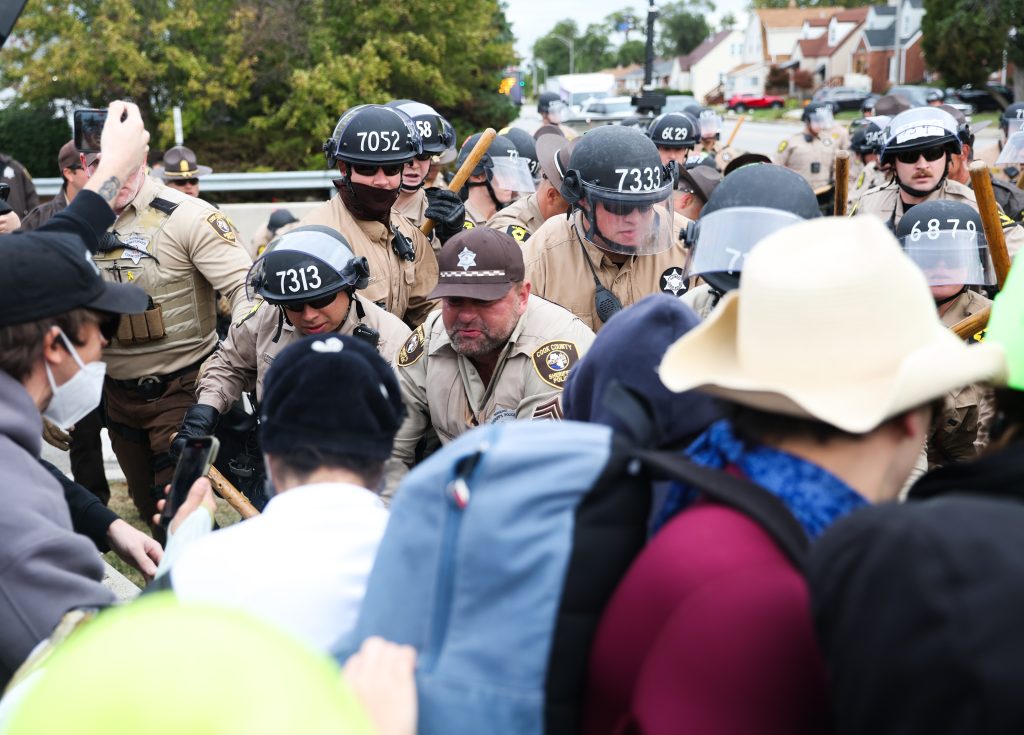 Illinois State Police troopers and Cook County Sheriff deputies shove protesters during a protest outside the Immigration and Customs Enforcement (ICE) processing facility in Broadview on Friday, Oct. 10, 2025. (Talia Sprague/Block Club Chicago)
