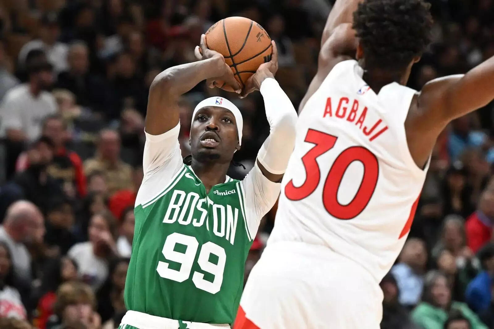 Boston Celtics forward Chris Boucher (99) shoots the ball past Toronto Raptors guard Ochai Agbaji (30) (Image via Imagn) Boston Celtics forward Chris Boucher (99) shoots the ball past Toronto Raptors guard Ochai Agbaji (30)