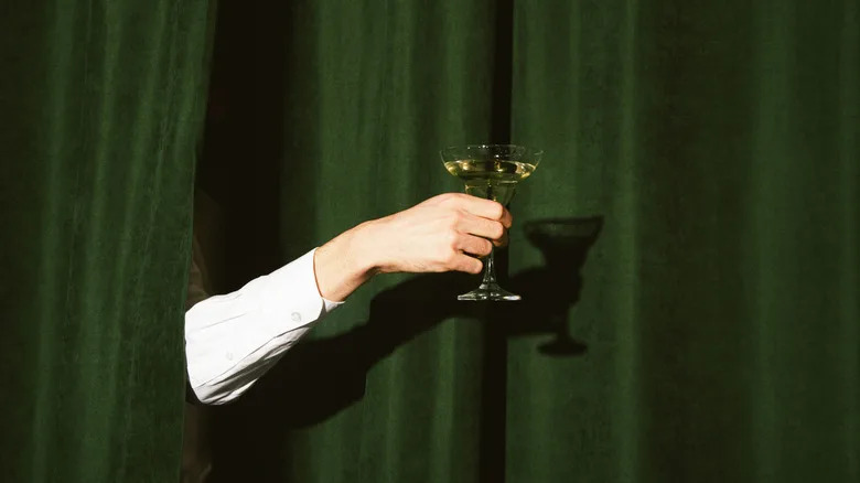 Hand holding a martini glass