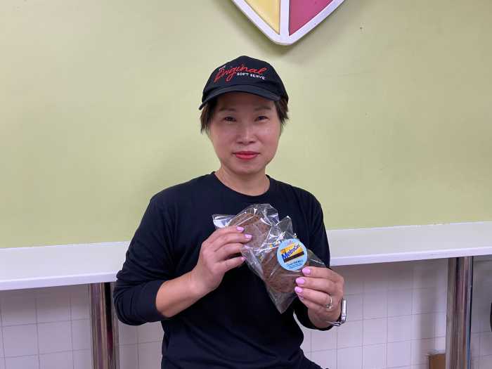 Fantastic fare-well: How the MTA and famous NYC food vendors are giving the MetroCard a delicious departure 3 woman in an ice cream shop were a black shirt and black hat