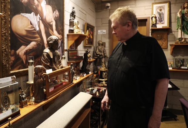 The Rev. Dennis O'Neill views relics on display in the sanctuary of the Shrine of All Saints at St. Martha Church on April 16, 2019, in Morton Grove. (John J. Kim/Chicago Tribune)