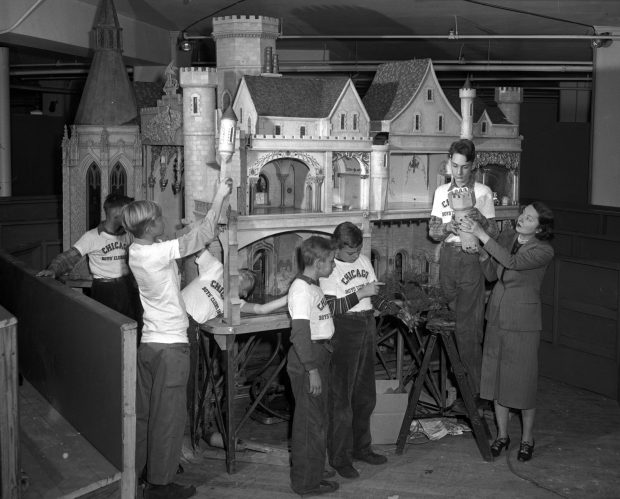 Boys from the Chicago Boys Club help assemble Colleen Moore's lavish dollhouse at The Fair Store in 1948. Proceeds from the exhibition went to the club. (Howard Borvig/Chicago Herald-American)