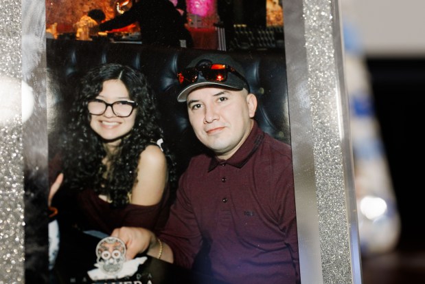 A photo of Ofelia Torres and her father, Ruben Torres Maldonado, on display in the family's living room on Oct. 20, 2025. (Armando L. Sanchez/Chicago Tribune)