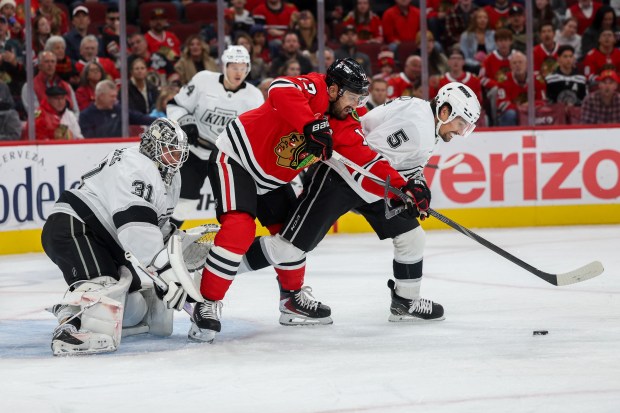 Los Angeles Kings defenseman Cody Ceci (5) and Chicago Blackhawks left wing Nick Foligno (17) fight for possession of the puck during the first period at the United Center Sunday Oct. 26, 2025 in Chicago. (Armando L. Sanchez/Chicago Tribune)