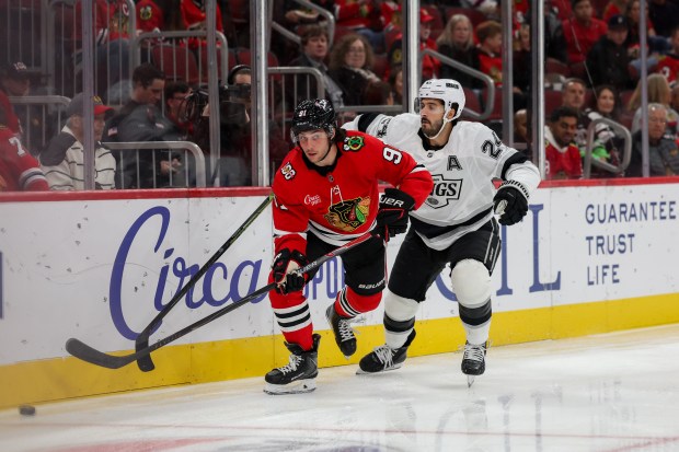 Chicago Blackhawks center Frank Nazar (91) and Los Angeles Kings center Phillip Danault (24) chase after the puck during the first period at the United Center Sunday Oct. 26, 2025 in Chicago. (Armando L. Sanchez/Chicago Tribune)