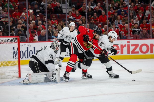 Los Angeles Kings defenseman Cody Ceci (5) and Chicago Blackhawks left wing Nick Foligno (17) fight for possession of the puck during the first period at the United Center Sunday Oct. 26, 2025 in Chicago. (Armando L. Sanchez/Chicago Tribune)