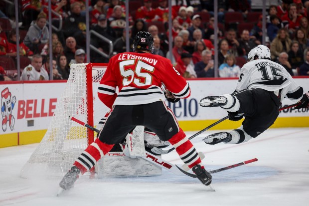 Los Angeles Kings center Alex Turcotte (15) falls on the ice during the second period against the Chicago Blackhawks at the United Center Sunday Oct. 26, 2025 in Chicago. (Armando L. Sanchez/Chicago Tribune)