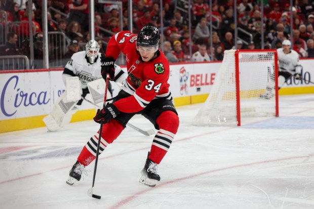 Chicago Blackhawks center Colton Dach (34) handles the puck during the first period against the Los Angeles Kings at the United Center Sunday Oct. 26, 2025 in Chicago. (Armando L. Sanchez/Chicago Tribune)