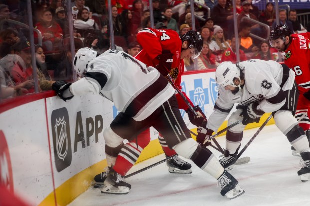 Los Angeles Kings defenseman Drew Doughty (8), Los Angeles Kings center Anze Kopitar (11) and Chicago Blackhawks center Colton Dach (34) fight for possession of the puck during the first period at the United Center Sunday Oct. 26, 2025 in Chicago. (Armando L. Sanchez/Chicago Tribune)