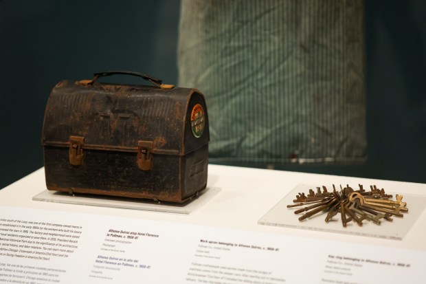 The lunch pail, worker's apron, and set of metal keys of former Pullman worker 89-year-old Alfonso Quiroz are on display in the "Aquí en Chicago," exhibition at the Chicago History Museum on Wednesday, Oct. 22, 2025. (Eileen T. Meslar/Chicago Tribune)