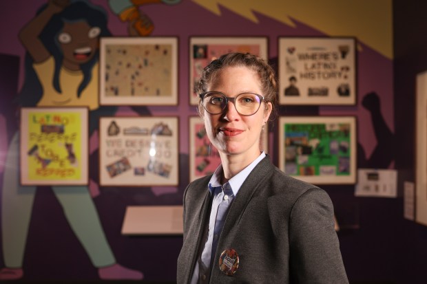 Curator Elena Gonzales stands in front of students' protest posters from 2019 in the "Aquí en Chicago" exhibition at the Chicago History Museum, Oct. 22, 2025. (Eileen T. Meslar/Chicago Tribune)