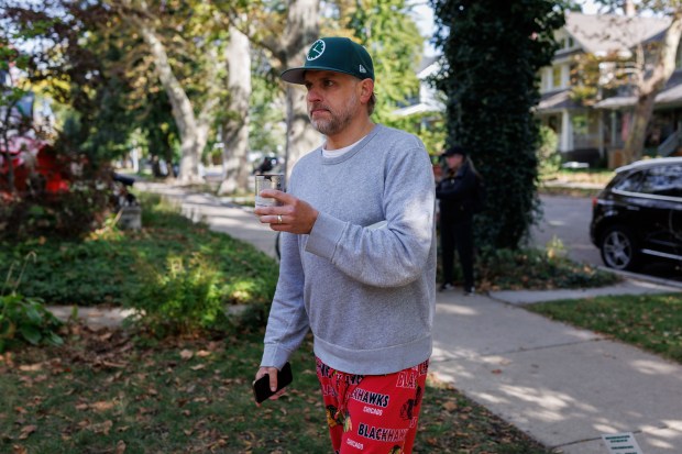 Brian Kolp carries tear gas near his home that was used by border patrol officers at the scene where residents say a landscaper worker, a resident of the area, and a woman on a bike were detained on the 3700 block of North Kildare Avenue Saturday Oct. 25, 2025 in Chicago. (Armando L. Sanchez/Chicago Tribune)