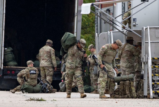 Members of the Texas National Guard arrive Oct. 7, 2025,...