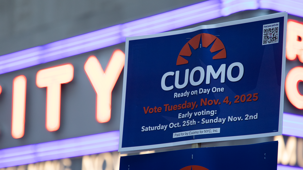 Former Gov. Andrew Cuomo supporter holds a sign