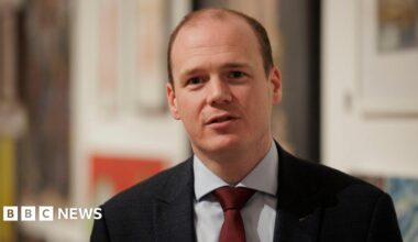 Jensen Huang, CEO of Nvidia, speaks during a news conference in Taipei in May. He is pictured holding a semiconductor unit while addressing the crowd.