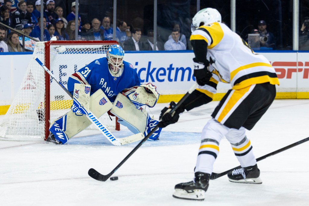 New York Rangers goaltender Igor Shesterkin (31) defends against a Pittsburgh Penguins player.