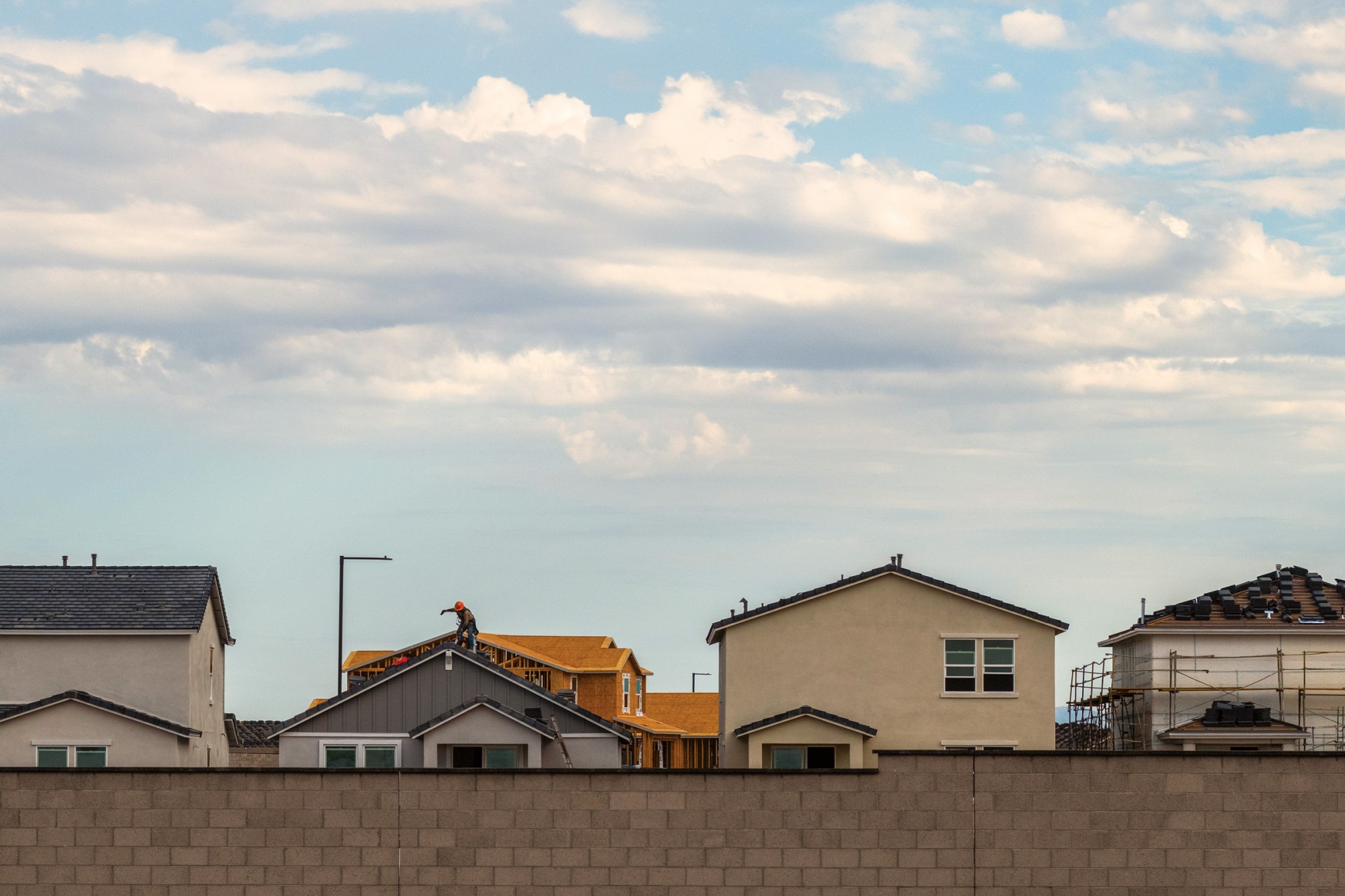 A roofer works on a home in a housing development in Buckeye, Arizona, in September.