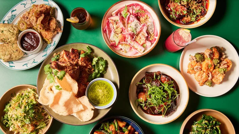Several dishes and drinks from Potluck Club laid out on a green background