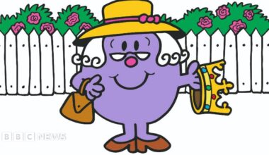 Miss Marple is purple and is wearing a hat, while Mr Poirot has his signature moustache, hat and cane.