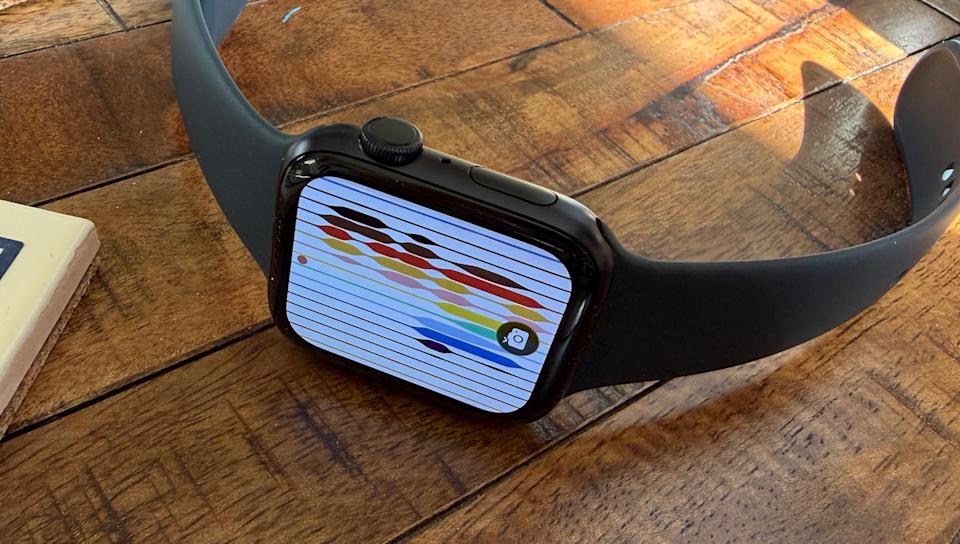 A photo of the Watch SE 3 on its side, displaying one of the available Pride-themed faces.