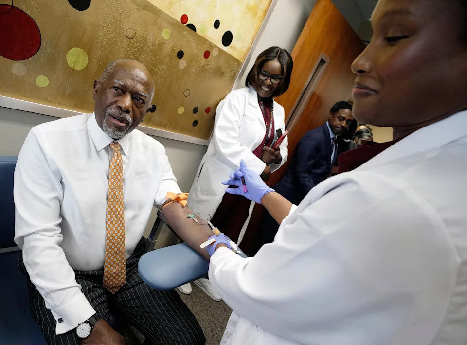 Meharry Medical College Clinical Research Coordinator Kayla Bean, draws blood from CEO and President Dr. James Hildreth as he gives blood at the Meharry Medical College's Center for Excellence in Clinical and Translational Research Monday, Oct. 6, 2025 in Nashville, Tenn. Meharry is launching a study to increase the global genomic database to include more people of African ancestry because they now only comprise 2% or less of the data. Expanding the database will help predict disease risks and guide prevention and treatment.