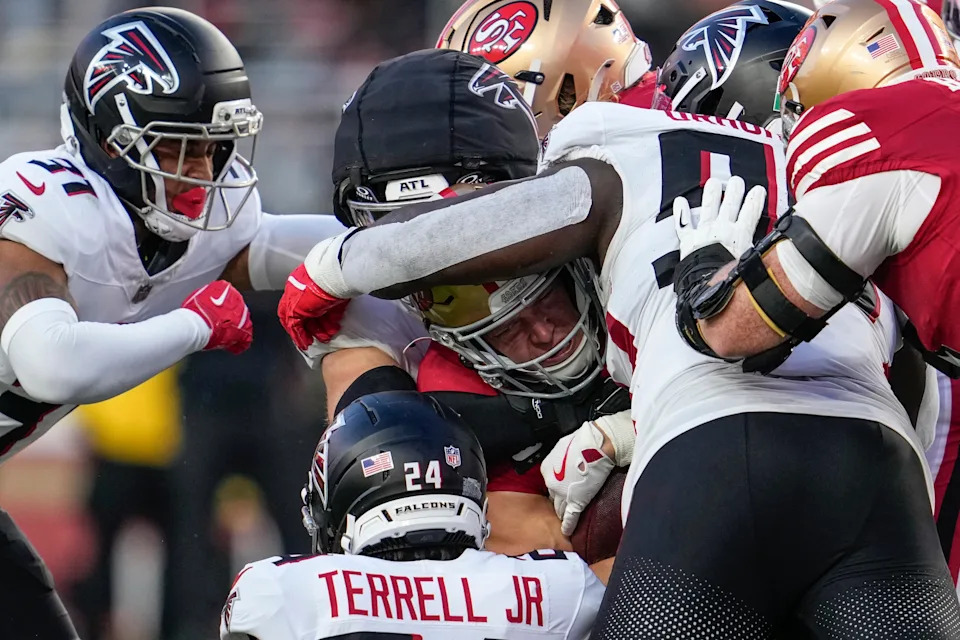 San Francisco 49ers running back Christian McCaffrey (23) is hit by the Atlanta Falcons defense in the first half of an NFL football game, Sunday, Oct. 19, 2025, in Santa Clara, Calif. (AP Photo/Godofredo A. Vásquez)