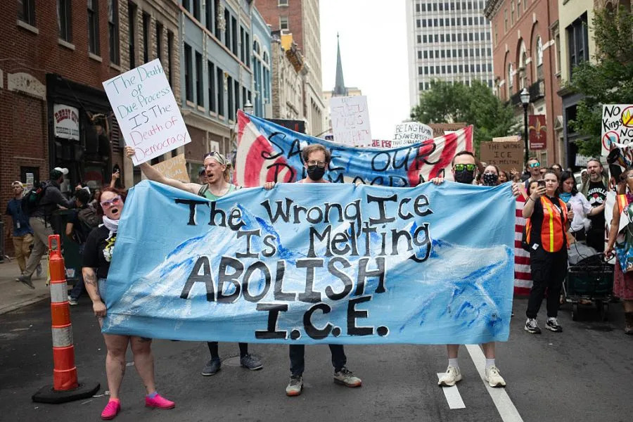 Protesters hold banners and placards as they march during a nationwide “No Kings” rally in downtown Louisville, Kentucky, on June 14, 2025, on the same day as President Donald Trump’s military parade in Washington, DC. Thousands of people rallied across the United States on June 14 as a so-called “No Kings” has sprung up against the policies of US President Donald Trump, ahead of a rare military parade on his 79th birthday. (Photo by LEANDRO LOZADA / AFP) (Photo by LEANDRO LOZADA/AFP via Getty Images)