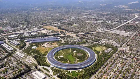 Getty Images An aerial view of Silicon Valley. There are many buildings, and in the middle of the frame a large circular building in the middle of a park.