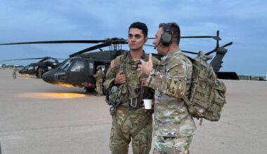Colonel Kamil Sztalkoper talks with another solider before boarding a Black Hawk helicopter. (Spectrum News 1/Blessing Iwuchukwu)