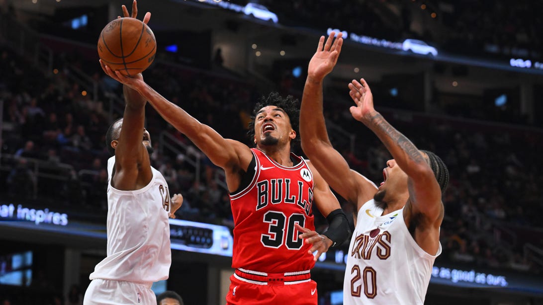 CLEVELAND, OHIO - OCTOBER 07: Tre Jones #30 of the Chicago Bulls shoots over Evan Mobley #4 and Jaylon Tyson #20 of the Cleveland Cavaliers during the second half of a preseason game at Rocket Arena on October 07, 2025 in Cleveland, Ohio.