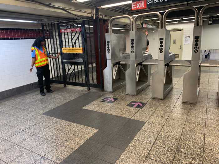 Fare evasion: MTA Police reports progress in stopping turnstile-hoppers at major transit hubs in NYC 2 woman in an orange vest near turnstiles in a subway station
