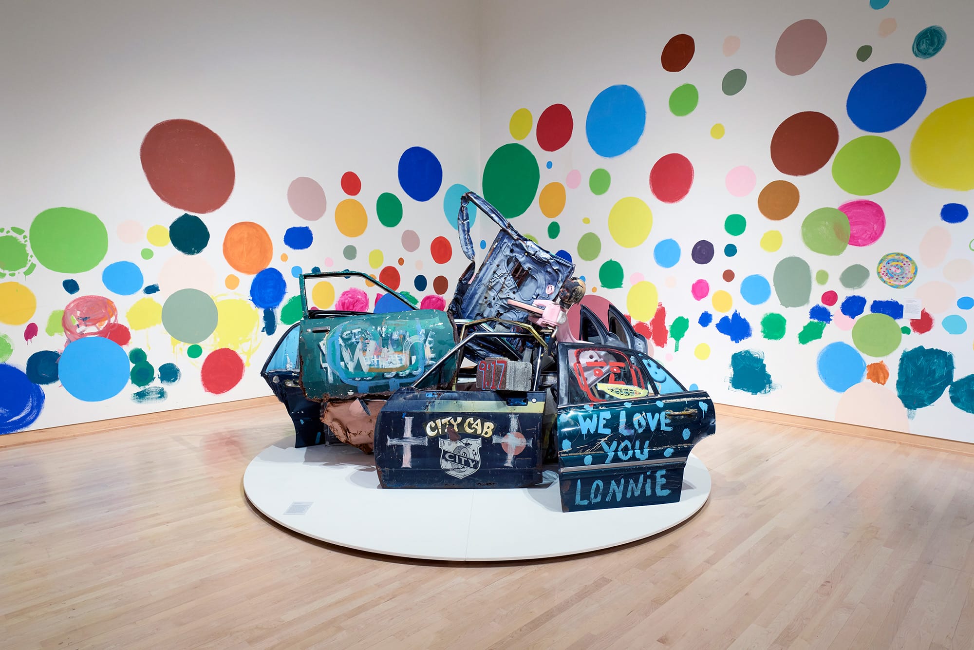 an installation of car doors by Tyree Guyton against polka dotted walls