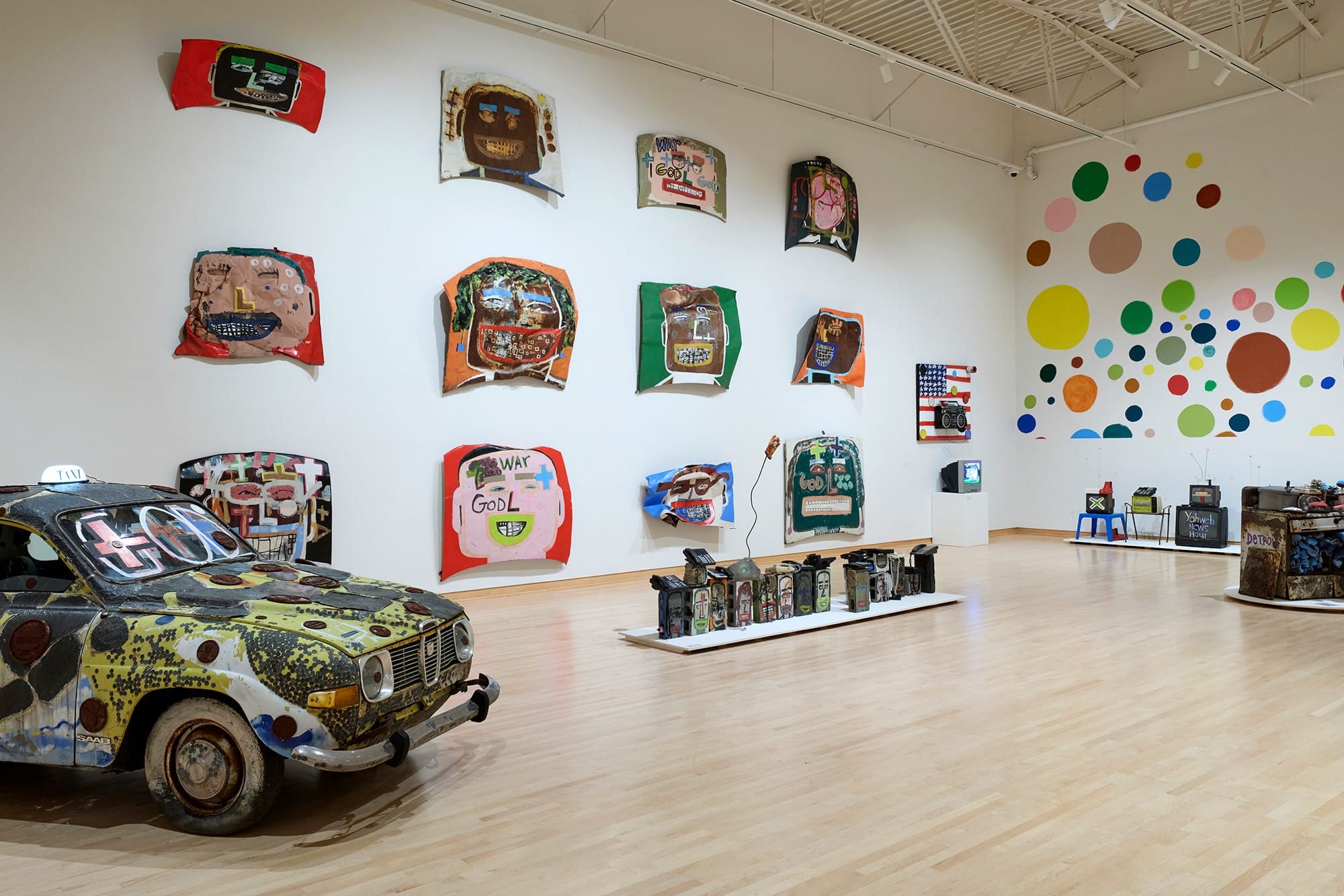 an installation of car doors by Tyree Guyton against polka dotted walls