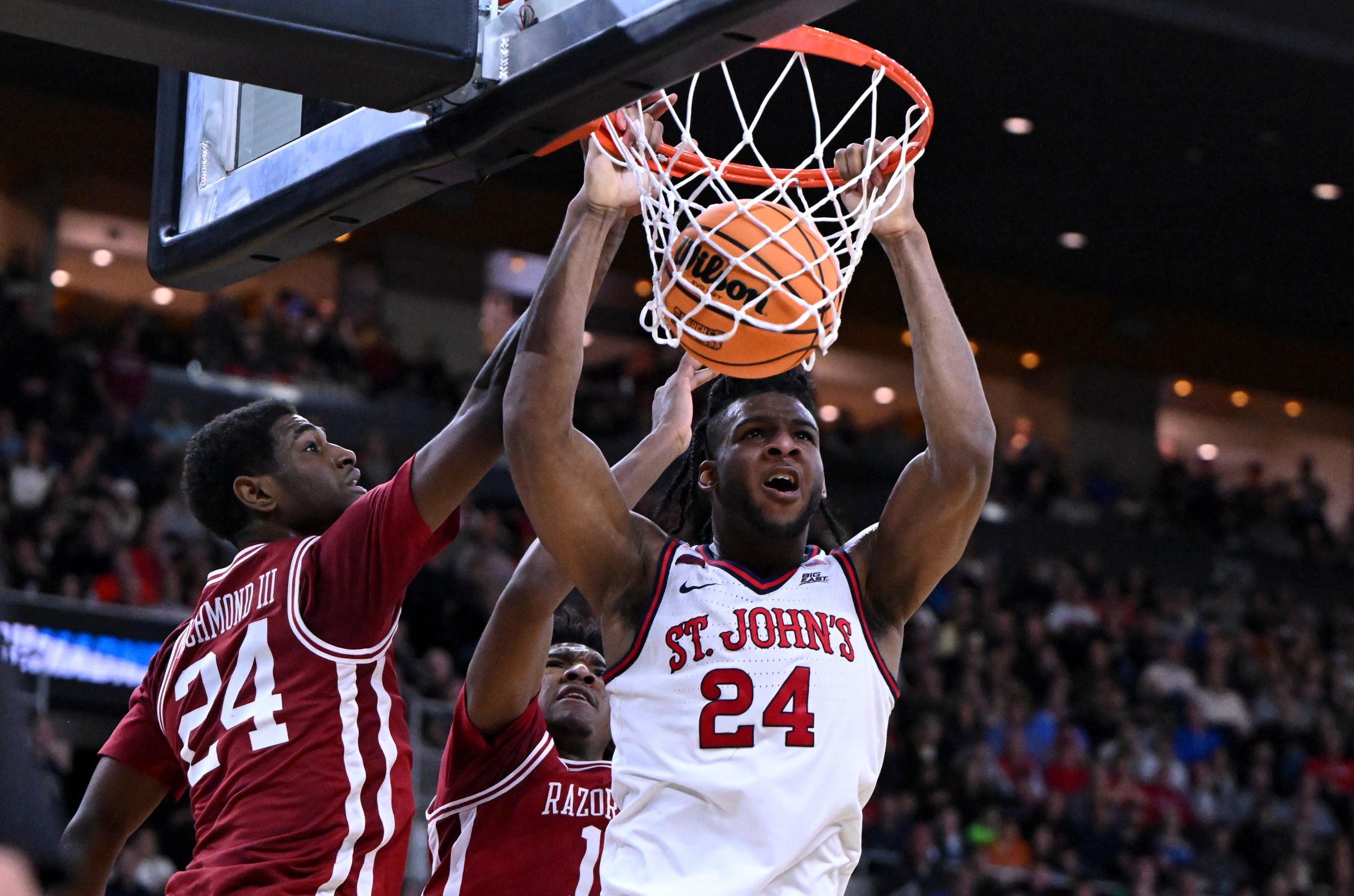Mar 22, 2025; Providence, RI, USA; St. John’s Red Storm forward Zuby Ejiofor (24) dunks against Arkansas Razorbacks forward Billy Richmond III (24) and guard Johnell Davis (1) during the second half of a second round men’s NCAA Tournament game at Amica Mutual Pavilion. Mandatory Credit: Brian Fluharty-Imagn Images