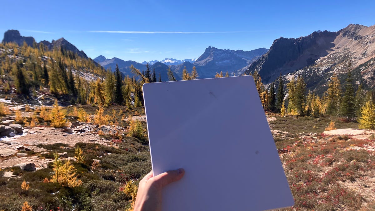 hand-holding-starlink-mini-dish-with-mountains-in-background