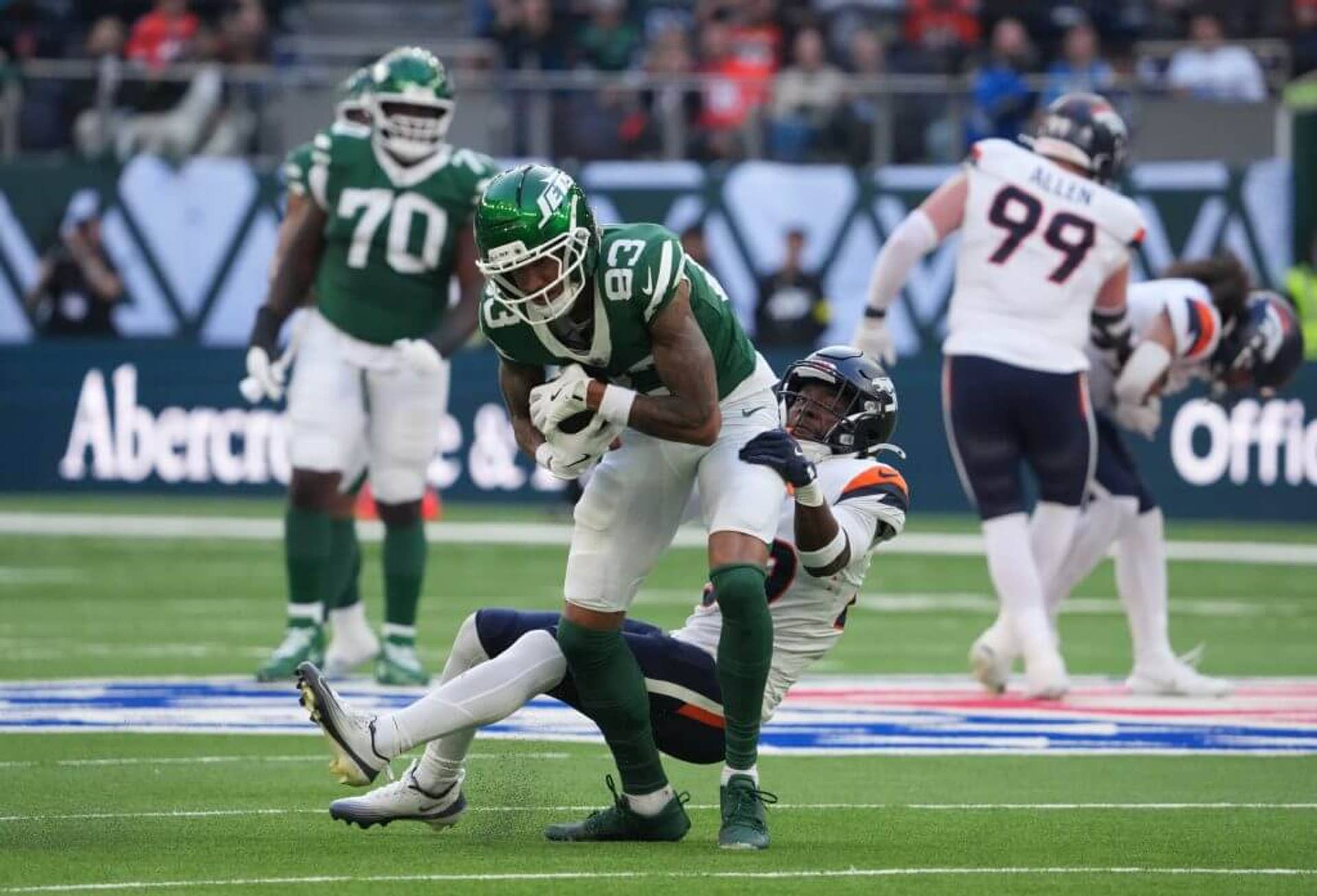 Jets wide receiver Josh Reynolds (83) is tackled by Denver Broncos cornerback Ja'Quan McMillian (29).