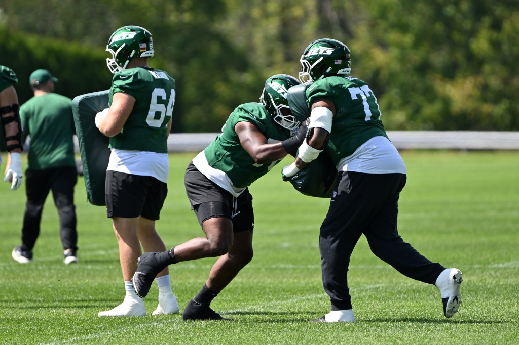 Jets guards John Simpson, left, and Marquis Hayes (77) practice in Florham Park, NJ. 